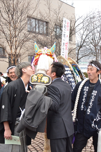 チャグチャグ馬コの前で記念撮影をする2人(チャグチャグ馬コへキスしている)