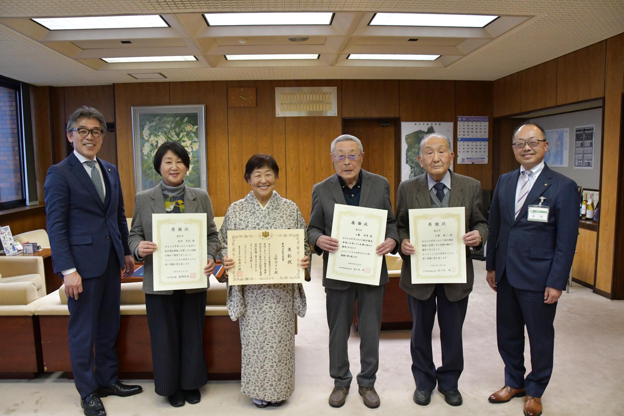 被表彰者の４人と市長の記念撮影